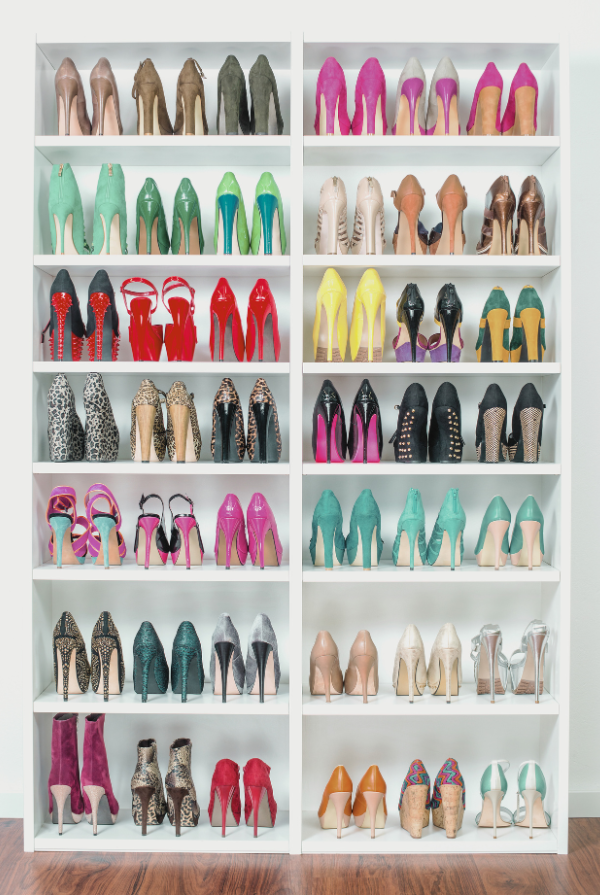 A neatly organized shoe rack with multiple shelves displaying a variety of high-heeled shoes in different colors and styles, showcasing effective shoe storage solutions for small spaces.