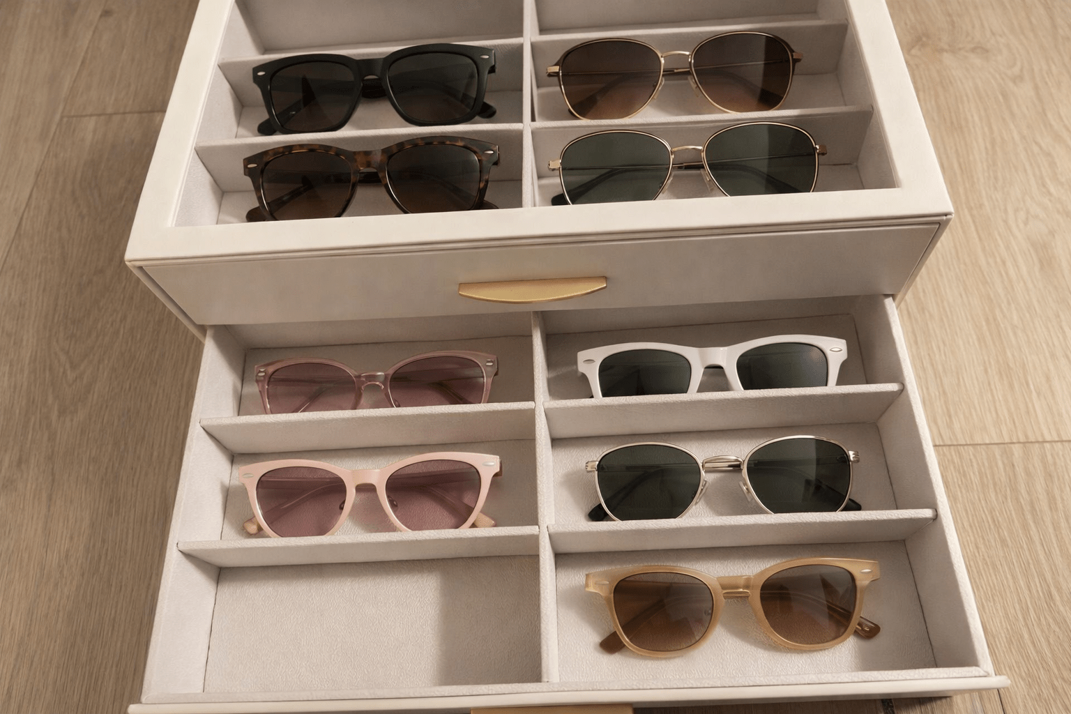 Organized sunglasses in a compartment storage box with separate slots to keep each pair visible and protected
